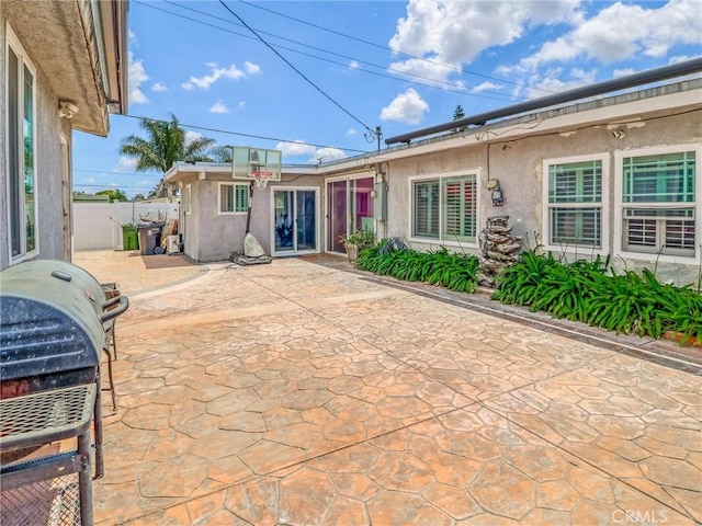 1401 W 165th St, Compton, CA 90220 - rear view of house with stucco siding, a patio, and fence