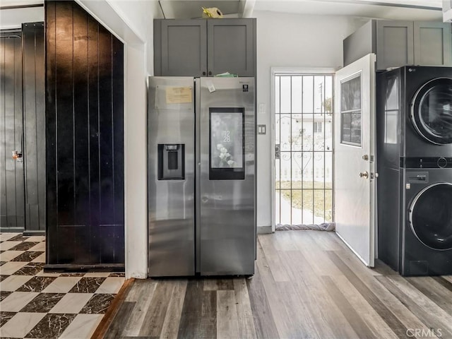 1401 W 165th St, Compton, CA 90220 - kitchen featuring stainless steel fridge with ice dispenser, estacked washer and dryer, light wood-style floors, and gray cabinets
