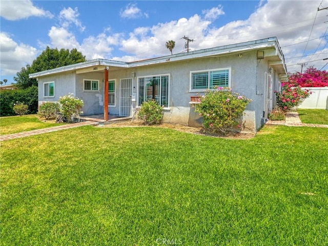 1401 W 165th St, Compton, CA 90220 - rear view of property featuring stucco siding and a yard