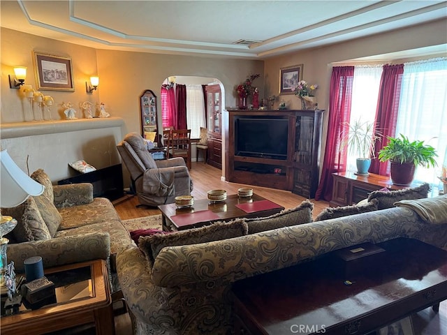 34662 Turner Ln, Yucaipa, CA 92399 - living room with healthy amount of natural light, arched walkways, a tray ceiling, and wood finished floors