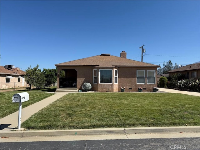 34662 Turner Ln, Yucaipa, CA 92399 - view of front facade featuring a front lawn, a chimney, roof with shingles, and stucco siding
