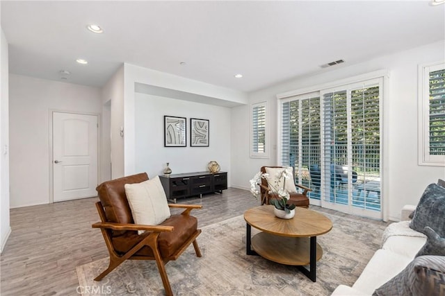 living area with wood finished floors, recessed lighting, and baseboards