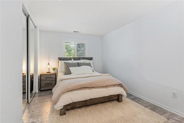 bedroom featuring wood finished floors and baseboards