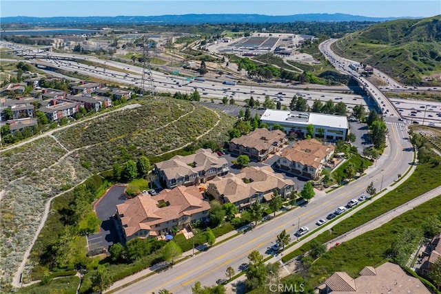 aerial view of property's location with a major roadway and a mountain backdrop
