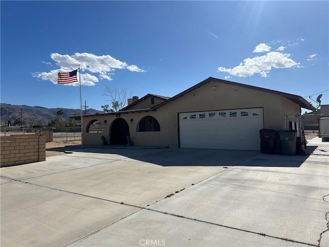 5888 Clare Ave Unit 29, Palms, CA 92277 - ranch-style house with fence, an attached garage, driveway, and stucco siding
