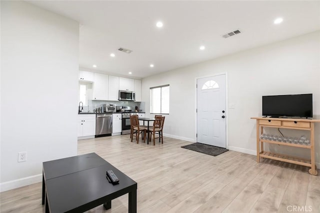 1411 Coolidge Ave, Pasadena, CA 91104 - living room featuring baseboards, light wood-type flooring, and recessed lighting