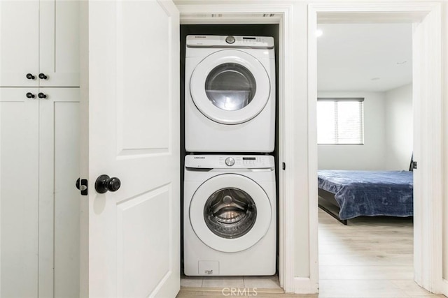 1411 Coolidge Ave, Pasadena, CA 91104 - washroom featuring stacked washer and clothes dryer and light wood-type flooring