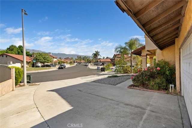 14881 Hawthorne Ave, Fontana, CA 92335 - view of road with a residential view, street lights, and a mountain view
