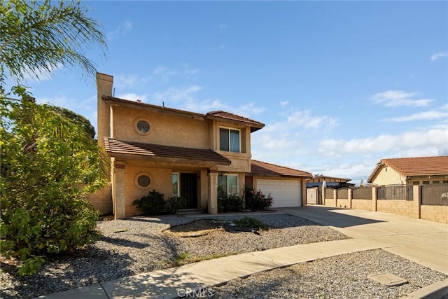 14881 Hawthorne Ave, Fontana, CA 92335 - view of front of house featuring driveway, a garage, fence, and stucco siding