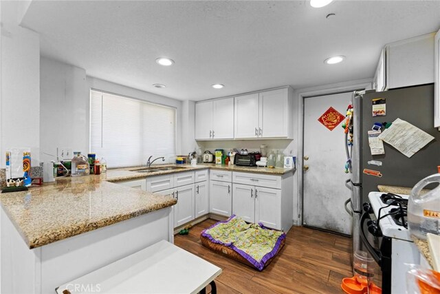 14881 Hawthorne Ave, Fontana, CA 92335 - kitchen with a sink, white cabinets, a peninsula, dark wood-style floors, and recessed lighting