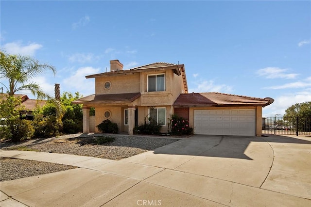 14881 Hawthorne Ave, Fontana, CA 92335 - view of front of property with driveway, an attached garage, fence, stucco siding, and a tiled roof