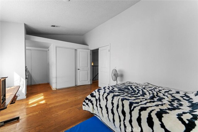 14881 Hawthorne Ave, Fontana, CA 92335 - bedroom with wood finished floors, lofted ceiling, a textured ceiling, and a closet