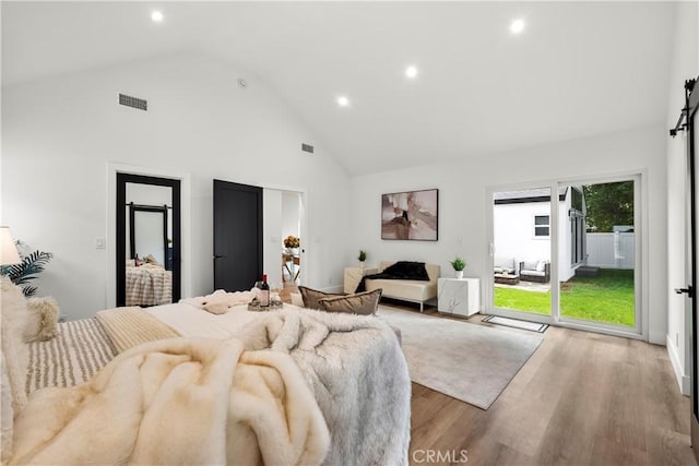 7307 Forbes Ave, Lake Balboa, CA 91406 - bedroom with access to outside, a barn door, high vaulted ceiling, recessed lighting, and wood finished floors