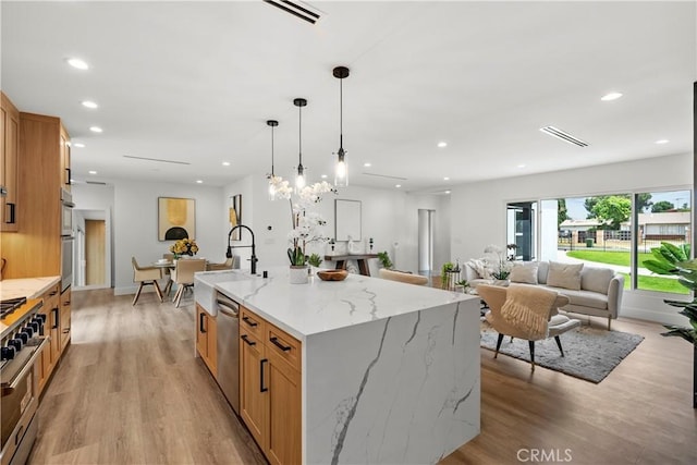 7307 Forbes Ave, Lake Balboa, CA 91406 - kitchen featuring stainless steel appliances, open floor plan, light wood-type flooring, recessed lighting, and a spacious island