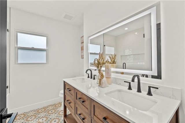 7307 Forbes Ave, Lake Balboa, CA 91406 - bathroom with double vanity, healthy amount of natural light, toilet, and baseboards