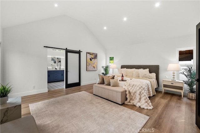 7307 Forbes Ave, Lake Balboa, CA 91406 - bedroom featuring a barn door, high vaulted ceiling, wood finished floors, baseboards, and recessed lighting