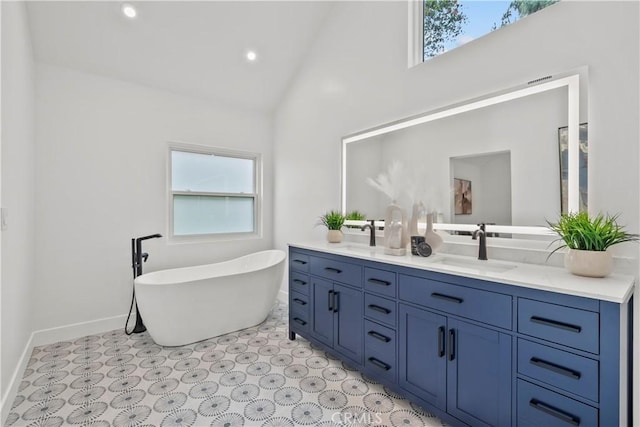 7307 Forbes Ave, Lake Balboa, CA 91406 - full bathroom with double vanity, plenty of natural light, baseboards, a soaking tub, and high vaulted ceiling