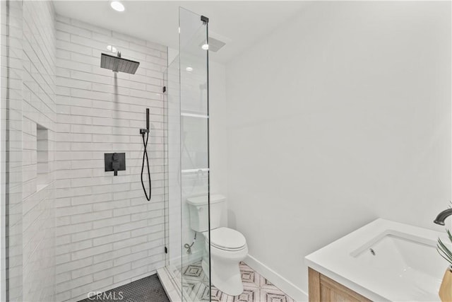 7307 Forbes Ave, Lake Balboa, CA 91406 - bathroom with vanity, tiled shower, toilet, baseboards, and recessed lighting