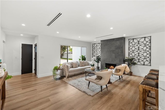 7307 Forbes Ave, Lake Balboa, CA 91406 - living room with a tile fireplace, recessed lighting, baseboards, and light wood-style flooring