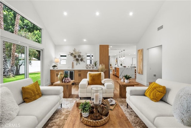 7307 Forbes Ave, Lake Balboa, CA 91406 - living area featuring high vaulted ceiling, beverage cooler, recessed lighting, light wood-style floors, and baseboards