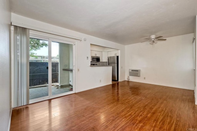 1307 Caminito Gabaldon Unit B, San Diego, CA 92108 - unfurnished living room with ceiling fan, wood finished floors, baseboards, and a wall unit AC