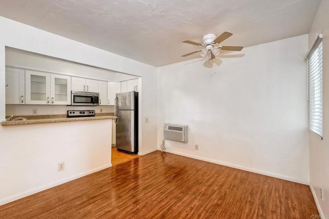 1307 Caminito Gabaldon Unit B, San Diego, CA 92108 - kitchen with stainless steel appliances, wood finished floors, ceiling fan, glass insert cabinets, and baseboards