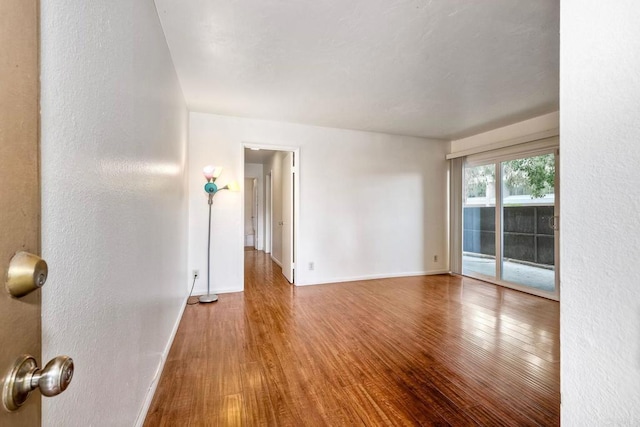 1307 Caminito Gabaldon Unit B, San Diego, CA 92108 - spare room with wood finished floors, baseboards, and a textured wall