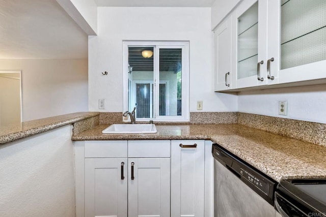 1307 Caminito Gabaldon Unit B, San Diego, CA 92108 - kitchen with a sink, stainless steel dishwasher, white cabinetry, light stone countertops, and glass insert cabinets