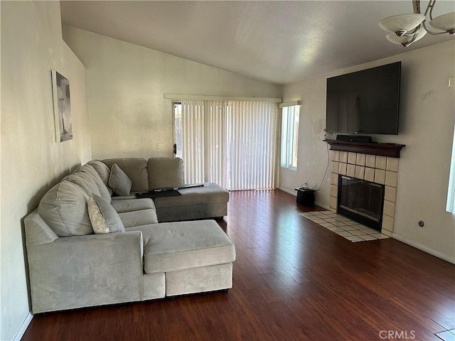 532 Hayes Cir, Corona, CA 92879 - living room with vaulted ceiling, hardwood / wood-style flooring, a tiled fireplace, and baseboards