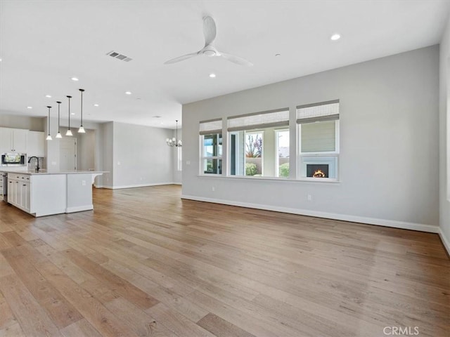 920 Trail View Pl, Nipomo, CA 93444 - unfurnished living room with recessed lighting, light wood finished floors, baseboards, a ceiling fan, and a sink