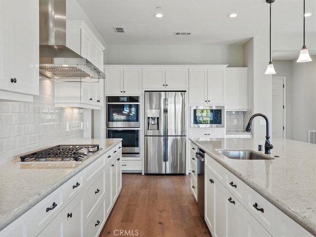 920 Trail View Pl, Nipomo, CA 93444 - kitchen featuring appliances with stainless steel finishes, wall chimney exhaust hood, a sink, white cabinets, and dark wood-style floors