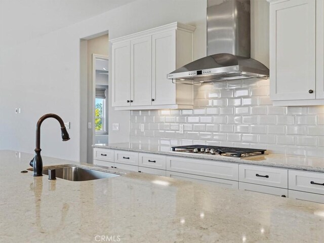 920 Trail View Pl, Nipomo, CA 93444 - kitchen featuring wall chimney exhaust hood, a sink, stainless steel gas cooktop, white cabinets, and backsplash