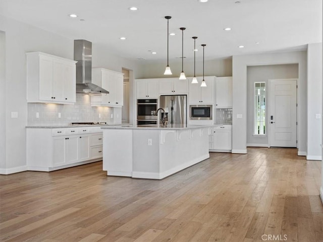 920 Trail View Pl, Nipomo, CA 93444 - kitchen with wall chimney exhaust hood, appliances with stainless steel finishes, light wood-style floors, light countertops, and decorative backsplash