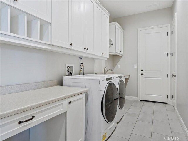 920 Trail View Pl, Nipomo, CA 93444 - washroom with cabinet space, independent washer and dryer, light tile patterned floors, and baseboards