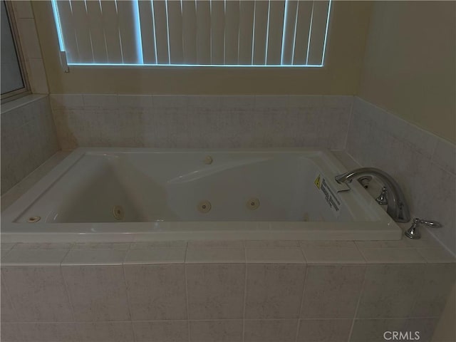bathroom featuring a tub with jets