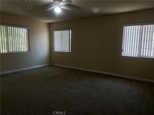 unfurnished room with a ceiling fan, carpet, plenty of natural light, and baseboards
