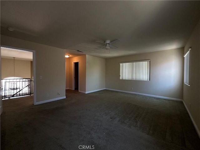 empty room with ceiling fan, baseboards, carpet, and plenty of natural light