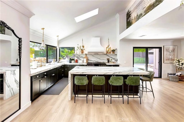 20139 Lake Canyon Dr, Walnut, CA 91789 - kitchen with premium range hood, a sink, a breakfast bar, plenty of natural light, and crown molding