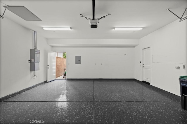 garage with electric panel, baseboards, and a garage door opener