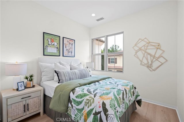 bedroom with light wood-style floors and baseboards