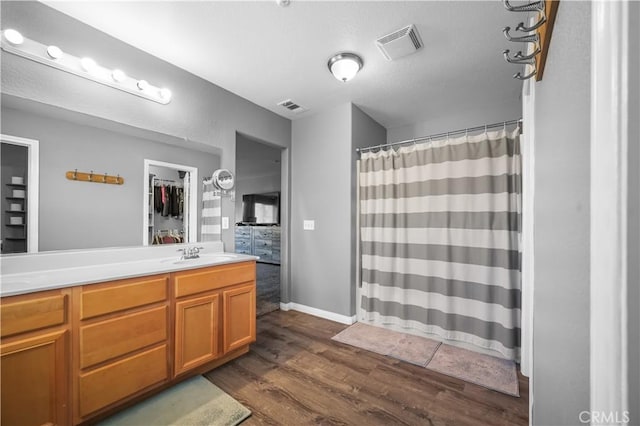 19883 San Juan Capistrano Ct, Riverside, CA 92508 - full bathroom featuring double vanity, wood finished floors, and a shower with shower curtain