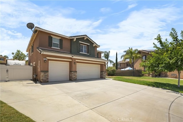 19883 San Juan Capistrano Ct, Riverside, CA 92508 - view of front of house featuring a garage, stone siding, stucco siding, and concrete driveway