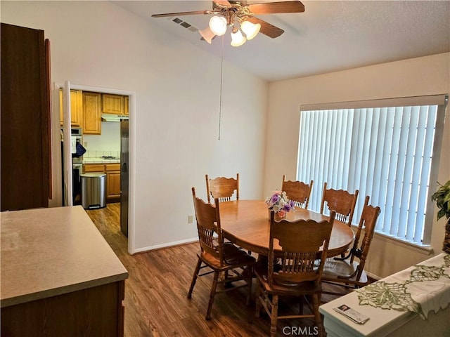 35823 48th St E, Palmdale, CA 93552 - dining space featuring ceiling fan, dark wood-style floors, baseboards, and lofted ceiling