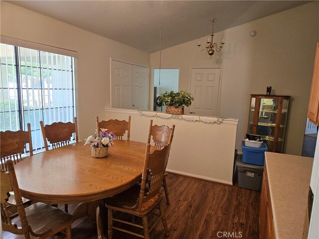 35823 48th St E, Palmdale, CA 93552 - dining area featuring dark wood finished floors, lofted ceiling, and a chandelier