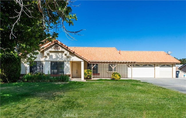 35823 48th St E, Palmdale, CA 93552 - ranch-style home with concrete driveway, an attached garage, a front yard, a tile roof, and stucco siding
