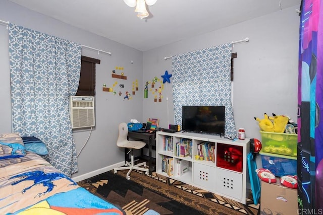 bedroom featuring baseboards and cooling unit