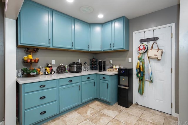 kitchen featuring blue cabinetry and light countertops
