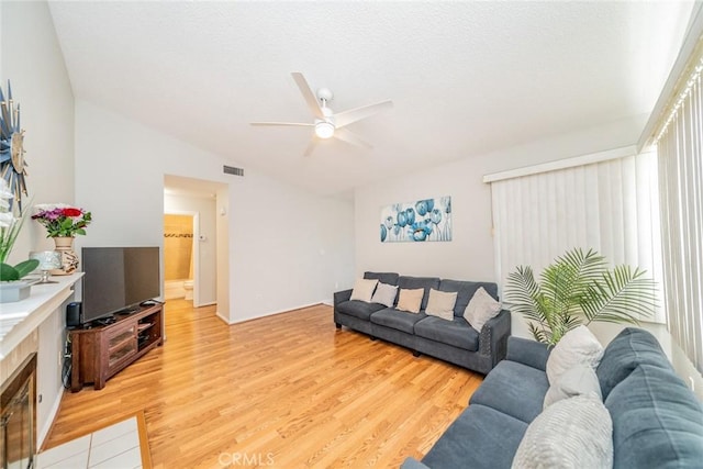 3628 Grizzley Creek Ct, Ontario, CA 91761 - living room with lofted ceiling, a ceiling fan, and light wood-style flooring