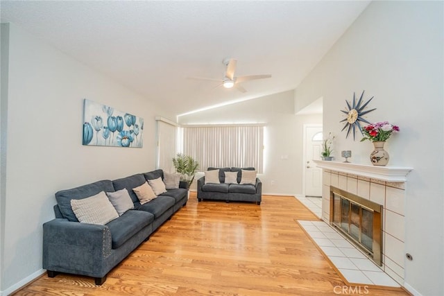 3628 Grizzley Creek Ct, Ontario, CA 91761 - living room with lofted ceiling, light wood-style floors, ceiling fan, a fireplace, and baseboards