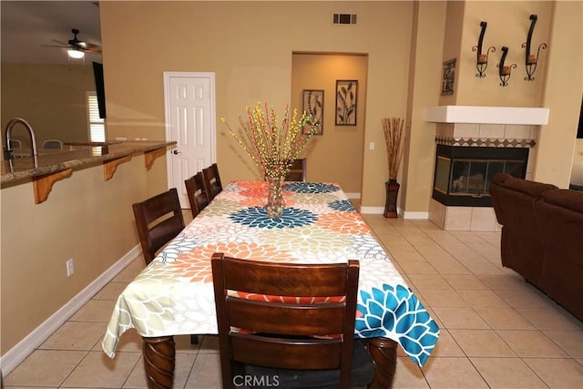 23618 Canyon Lake Dr N, Canyon Lake, CA 92587 - dining room with light tile patterned floors, a ceiling fan, a fireplace, and baseboards
